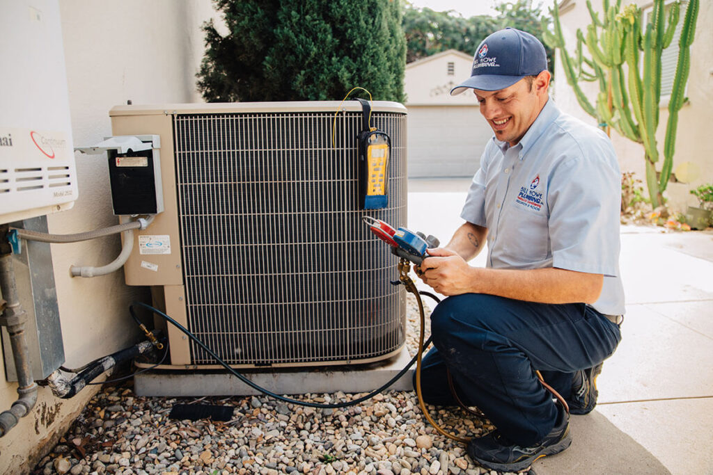 Air conditioning services and repair technician works on an AC unit